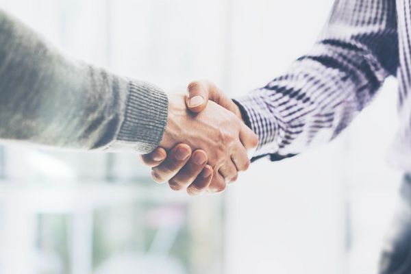 Business partnership meeting concept. Image businessmans handshake. Successful businessmen handshaking after good deal. Horizontal, blurred background
